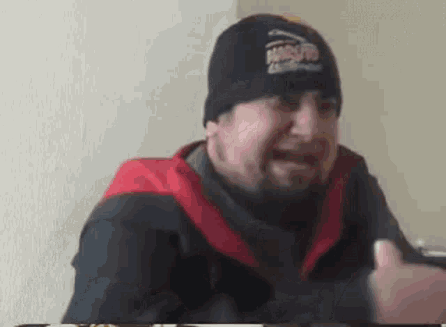 a man with a beard wearing a beanie that says jumbo jet