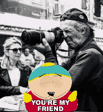a man is taking a picture of a woman with a south park character behind him