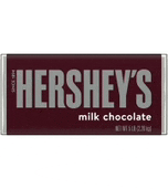 a bar of hershey 's milk chocolate is sitting on a table .