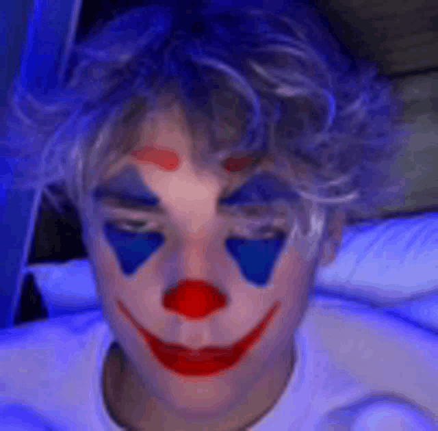 a person with a clown makeup on their face