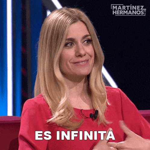 a woman in a red dress with the words es infinita on her shirt