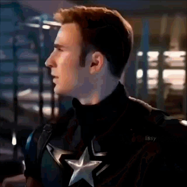 a close up of captain america 's face with a star on his chest in a dark room .