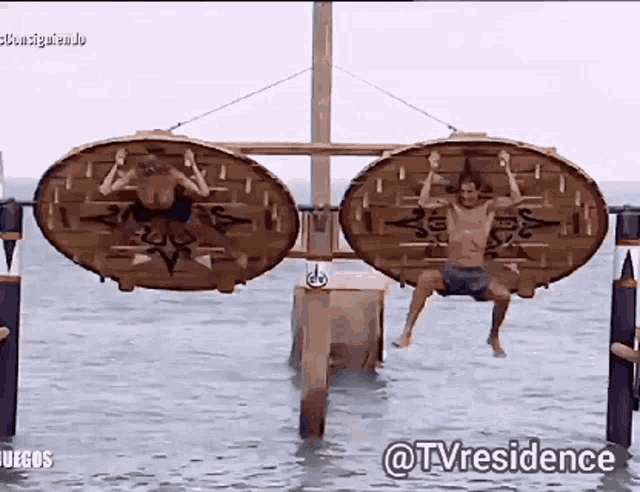 two men are hanging upside down in the water with the words @tvresidence on the bottom