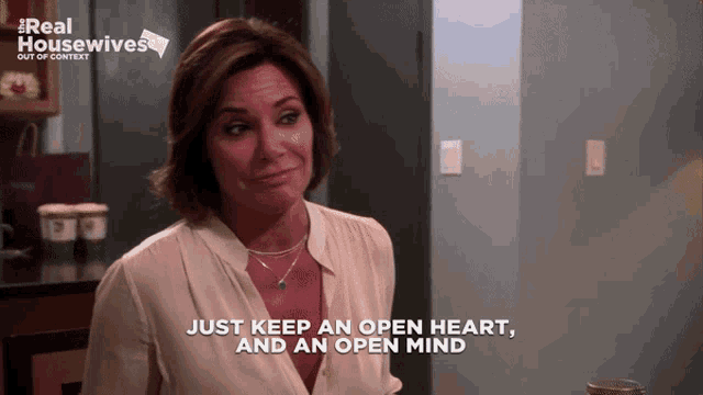 a woman says " just keep an open heart and an open mind " in front of a real housewives logo