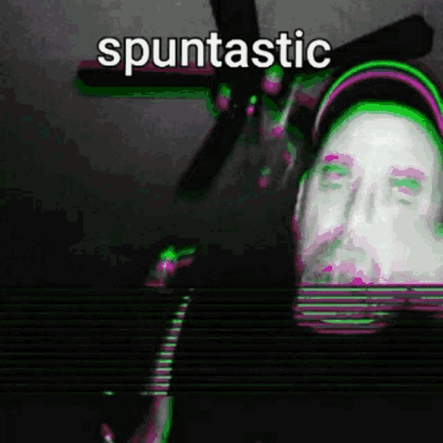 a man with a beard is standing in front of a ceiling fan with the words " spuntic " on the bottom