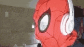a close up of a spider man wearing headphones .