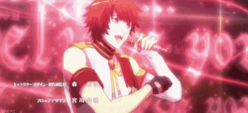 a young man with red hair is singing into a microphone .