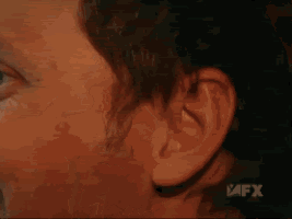 a close up of a person 's face with a fx logo in the corner
