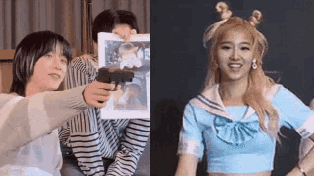 a man is pointing a gun at a picture of a girl and a woman is smiling .
