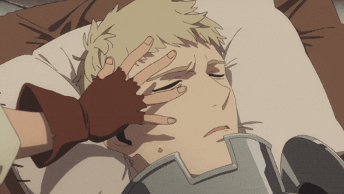 a person laying on a bed with their hand on their forehead