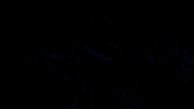 a man wearing glasses and a blue shirt is taking a picture