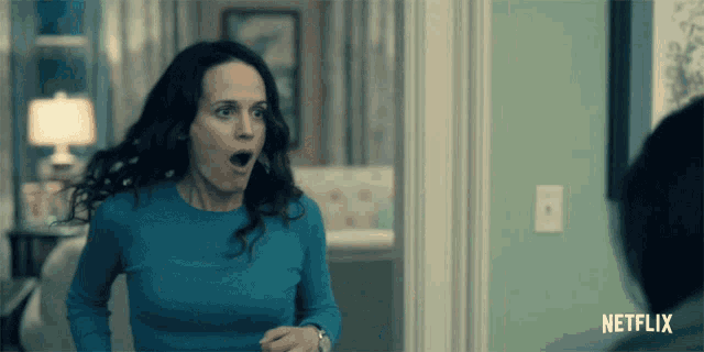 a woman with a surprised look on her face and a netflix logo in the corner