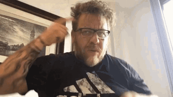 a man with a beard wearing glasses and a black adidas shirt