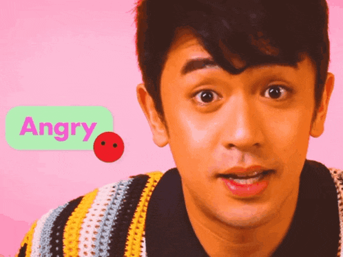 a man in a striped sweater has a green angry sticker on his face