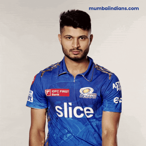 a man wearing a blue shirt with slice written on it