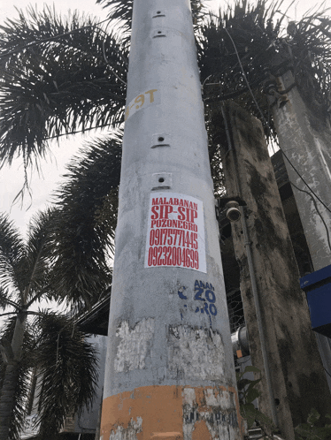 a pole has a sticker on it that says malabanan sip sip