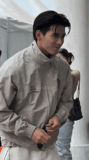 a man wearing a jacket that says ' a ' on the front