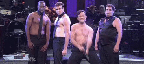 a group of men standing next to each other on a stage .