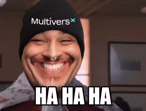 a man wearing a beanie with the word multiverse on it laughs