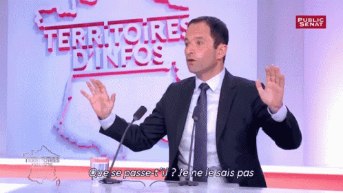 a man in a suit and tie is speaking into a microphone in front of a sign that says territories dinfos