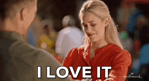 a woman in a red shirt is holding a man 's hand and saying i love it .