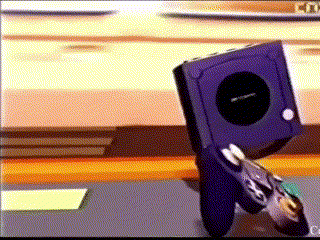 a nintendo gamecube is sitting on a table with a controller .