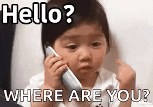 a baby is talking on a cell phone and making a face .