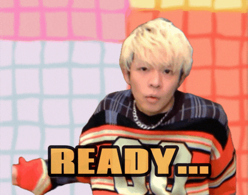 a man is wearing a sweater that says ready