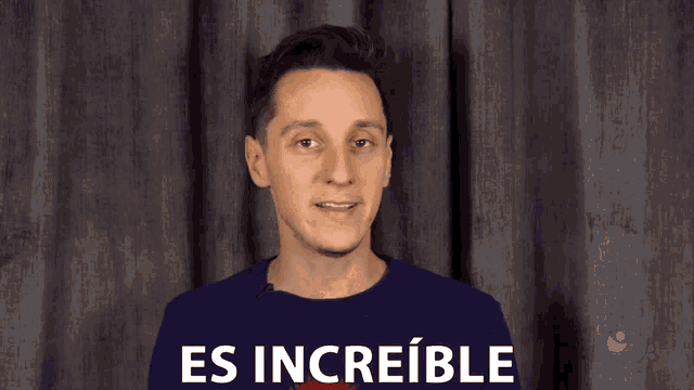 a man in a blue shirt is making a funny face with the word impresionante behind him