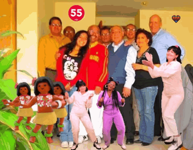 a group of people are posing for a picture in front of a wall with the number 55 on it