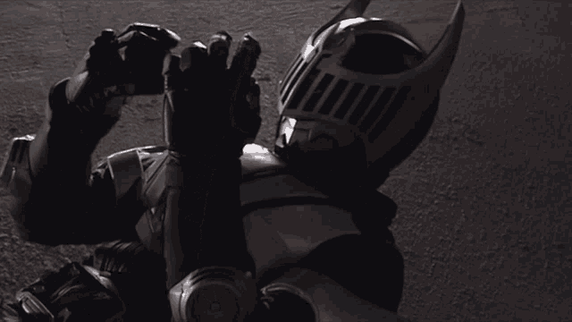 a man in a knight costume is laying on the ground with his hands up