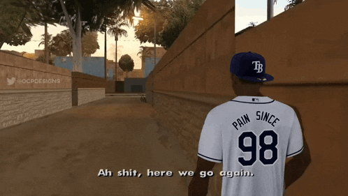 a man wearing a tb hat and a pain since 98 jersey