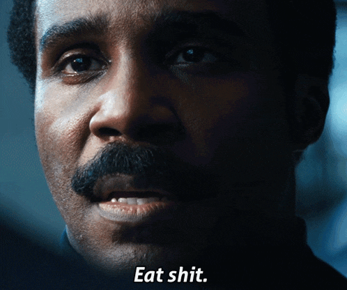 a close up of a man 's face with the caption eat shit