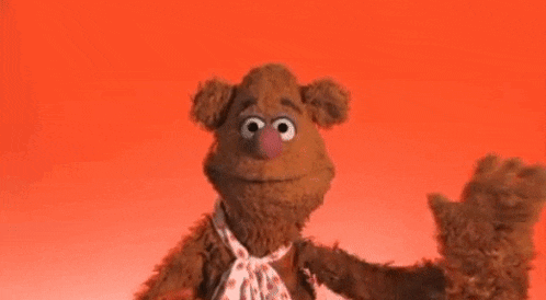 muppets fozzie bear is dancing on a red background .