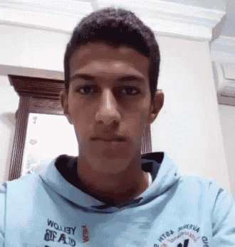 a young man wearing a light blue hoodie with the word wojjey on it