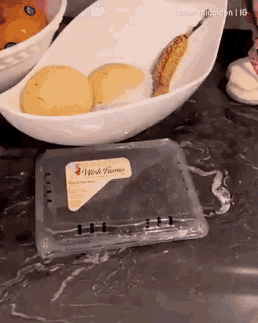 a plastic container with a wish farms label sits on a counter