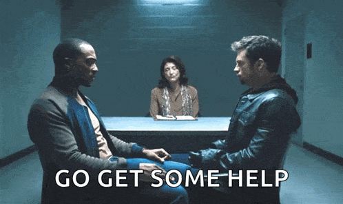 two men are sitting at a table with a woman behind them and the words go get some help on the bottom right