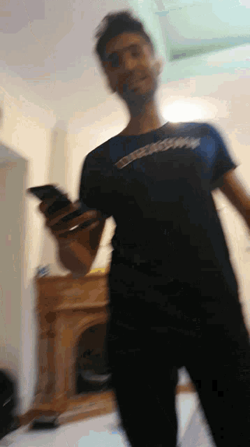 a blurry photo of a man wearing a black shirt that says ' spiderman ' on it