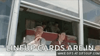 a group of people are sitting in front of a window and the words lineup cards are in are on the screen .