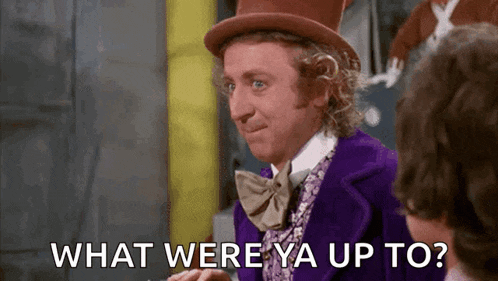 a man in a purple suit and top hat is talking to another man and asking what were ya up to .