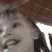 a close up of a woman 's face with a hat on .