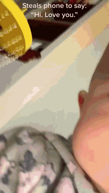 a baby steals a phone to say hi love you