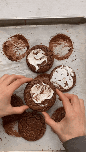 a person is holding a brownie with marshmallow frosting on it
