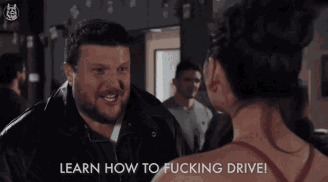 a man giving the middle finger to a woman with the words learn how to fucking drive written below him