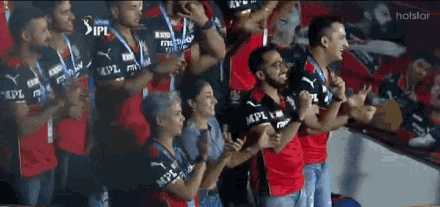 a group of people standing in a stadium wearing shirts that say mpl