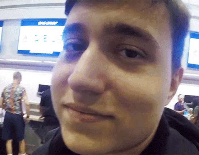 a man 's face is shown in front of a sign that says big drop