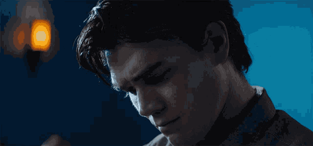 a close up of a man 's face with a light behind him