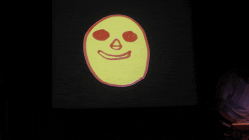 a yellow face with red eyes and the letter a on the nose