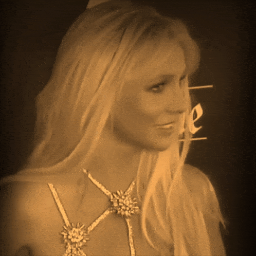 a woman with long blonde hair is wearing a necklace with flowers on it
