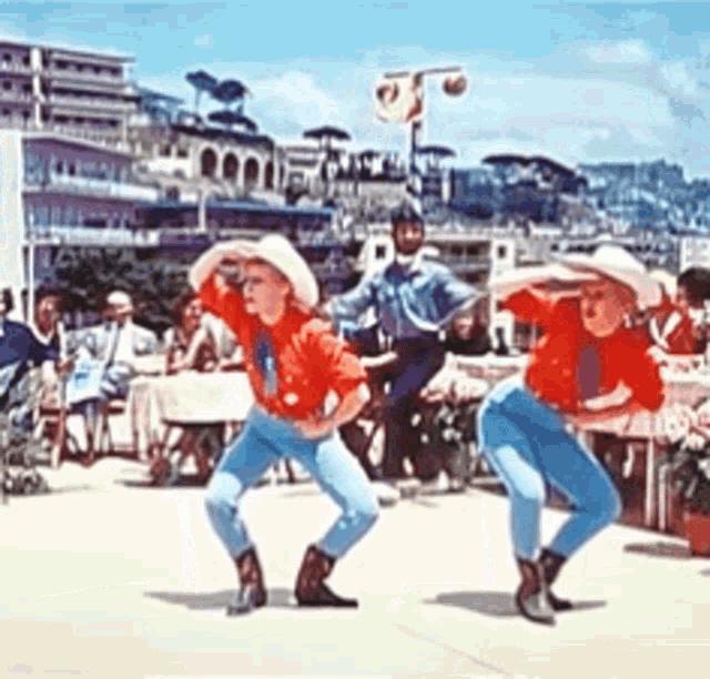 a group of people are dancing in front of a crowd of people .